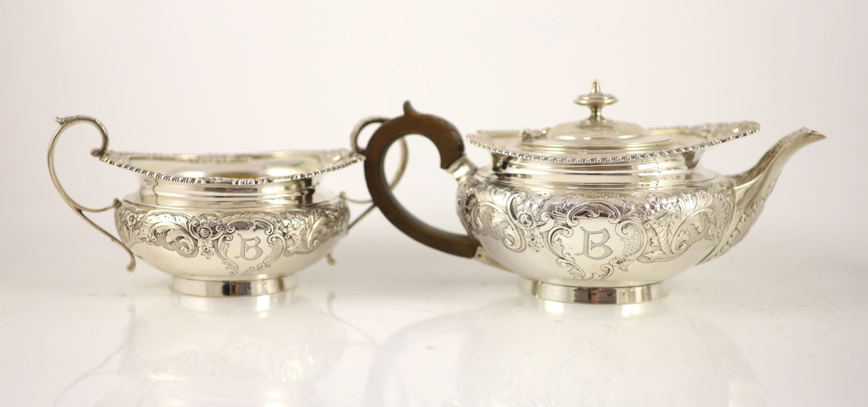 An Edwardian embossed silver circular four piece tea and coffee service by Edward Barnard & Sons Ltd